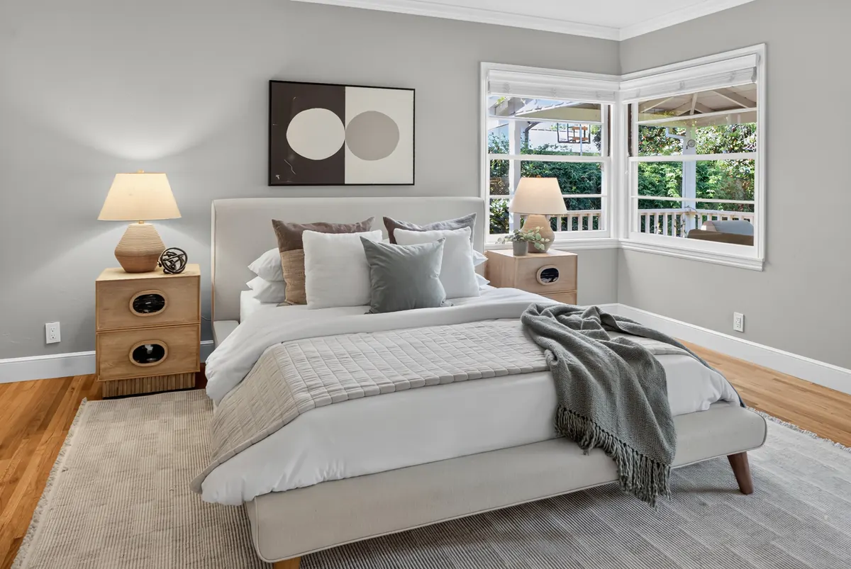 Bedroom with circle art and wood bedside chests