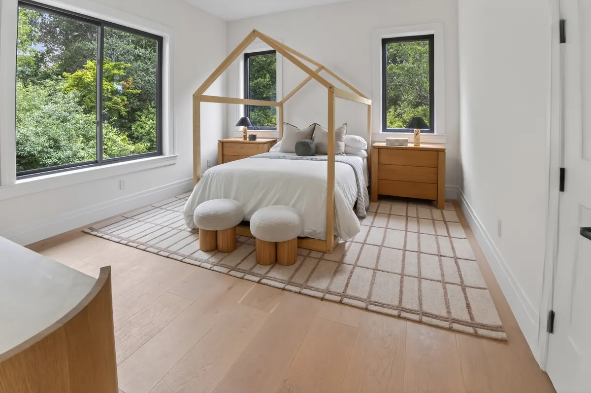 Kids' room with a house-frame bed and upholstered stools