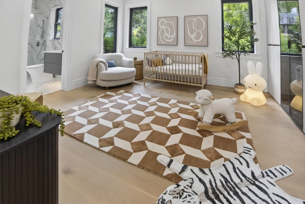 Nursery with a patterned rug and crib